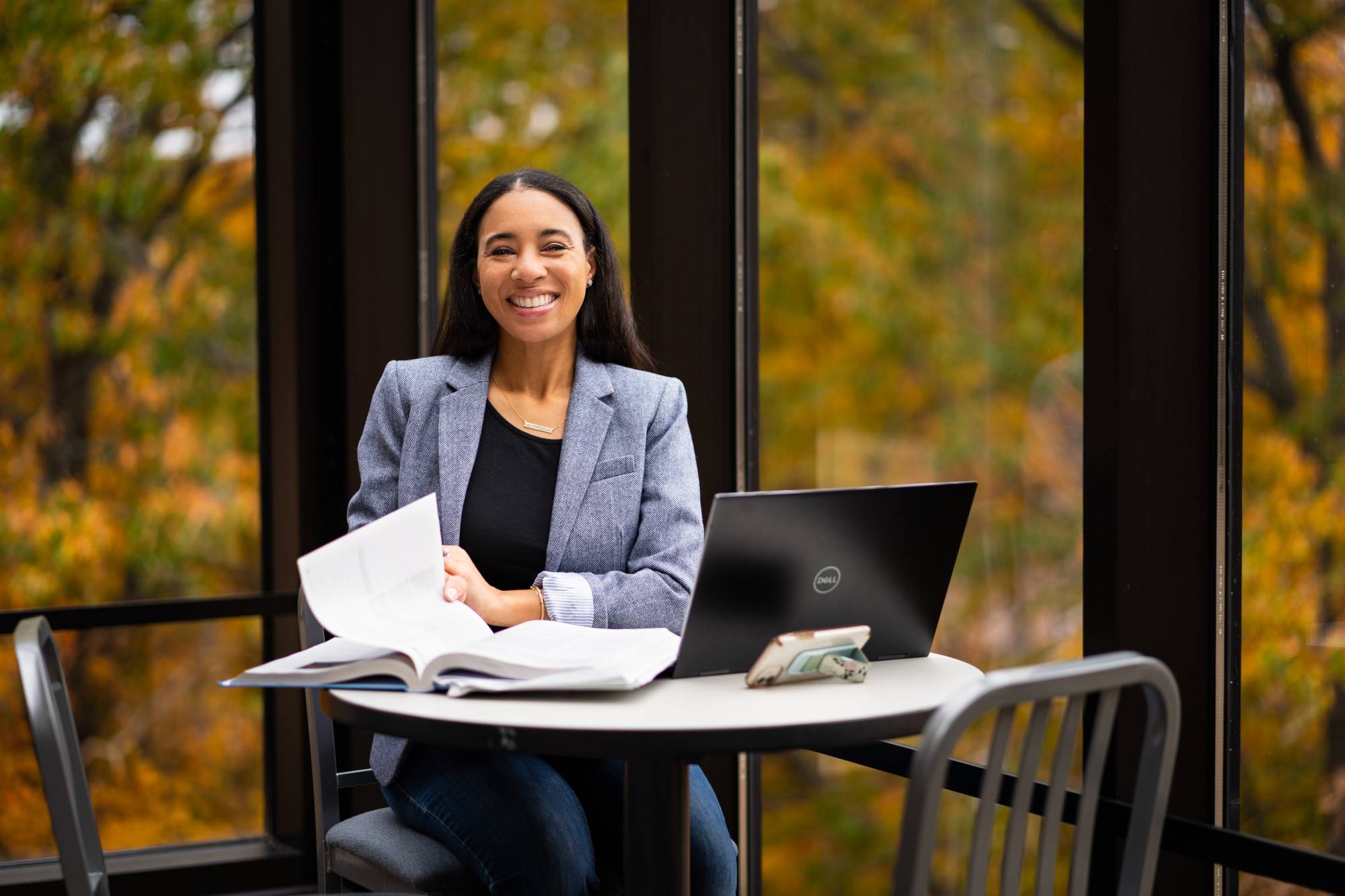 An alum smiles while working on her laptop